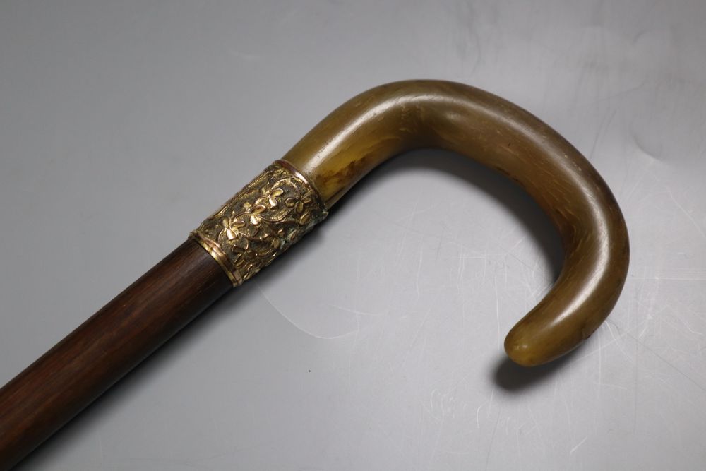 An Edwardian rhinoceros horn handled walking stick, presented 1906, length 88cm